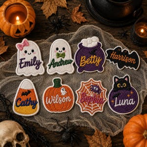 May include: A collection of eight embroidered Halloween-themed patches featuring various shapes including ghosts, a cauldron, a bat, candy corn, a pumpkin, a spider web, and a black cat, each personalized with names including Emily, Andrew, Betty, Harrison, Cathy, Wilson, Sophia, and Luna.