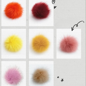 May include: A collection of eight fluffy, spherical pom-poms arranged in a grid. The colors include bright orange, deep red, vibrant yellow, mustard yellow, dusty pink, light purple, and beige. Hand-drawn heart and star symbols are visible.