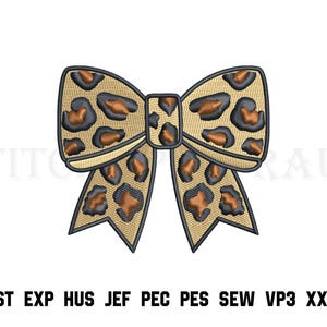 May include: An embroidered bow design featuring a tan background with a black and brown leopard print pattern. The bow is outlined in dark thread and includes the text DST EXP HUS JEF PEC PES SEW VP3 XXX at the bottom of the image.