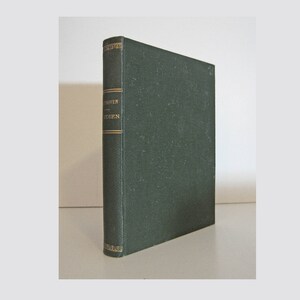 May include: A hardcover book with a dark green cover and gold lettering on the spine. The book is standing upright, with the spine facing the viewer. The title and author are visible on the spine.