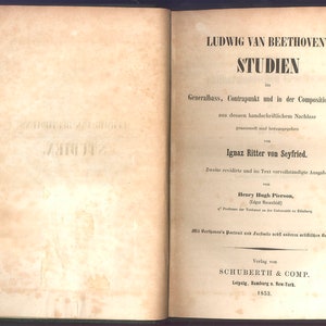 May include: An open book with the title "LUDWIG VAN BEETHOVEN'S STUDIEN" in large, bold letters. The book's pages are aged with text in German. The cover is dark green with a decorative border.