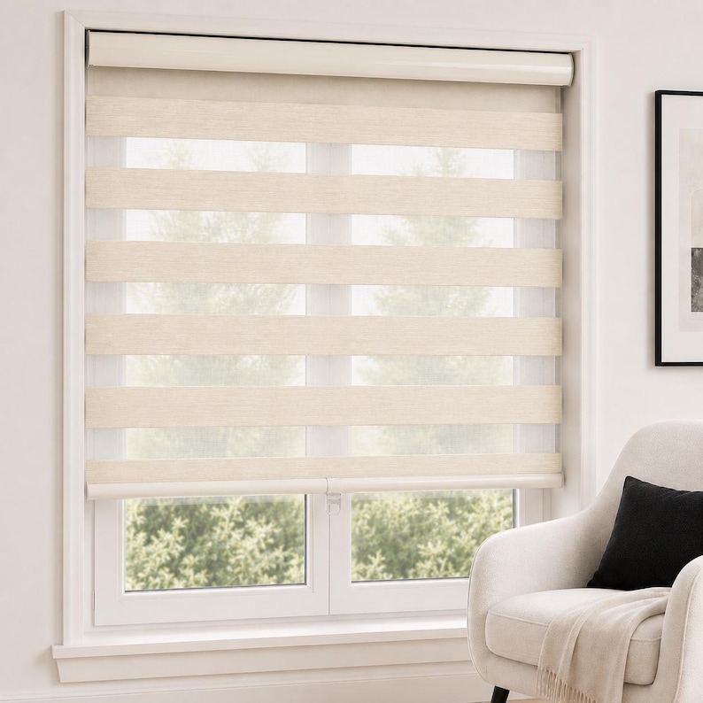Pu&ograve; includere: Una tenda a rullo a doppio strato con fasce orizzontali alternate di tessuto opaco color crema e rete bianca trasparente. La tenda &egrave; montata all'interno di un telaio bianco e presenta un design a strati per regolare la luce.
