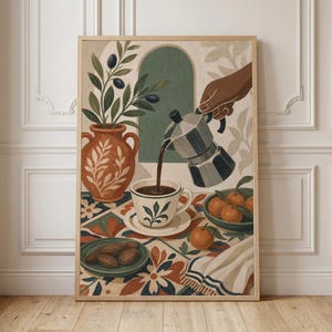 May include: A framed wall art print featuring a stylized illustration of a moka pot pouring coffee into a cup. The scene includes an orange vase with olive branches, a bowl of oranges, a plate of dates, and a patterned tablecloth in warm tones.