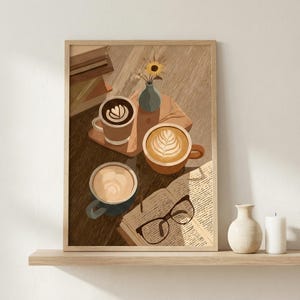 May include: A framed art print depicts a cozy coffee scene. Three mugs of coffee with latte art sit on a wooden table, alongside an open book and eyeglasses. A small vase with a sunflower is also present. The color palette is warm, with browns and creams.