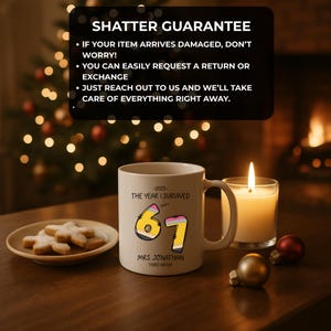 May include: A white ceramic mug with the text "-2025- THE YEAR I SURVIVED" and the numbers "67" designed as pencils. The mug also includes the name "MRS. JONATHAN" and "THIRD GRADE". A lit candle and cookies are also in the image.