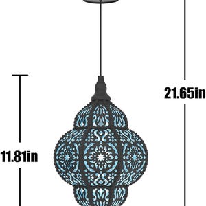 May include: Black metal hanging lantern with intricate cut-out patterns. The lantern is 21.65 inches tall and 6.30 inches wide, with a decorative design and a handle for hanging. The interior has a blue glow.