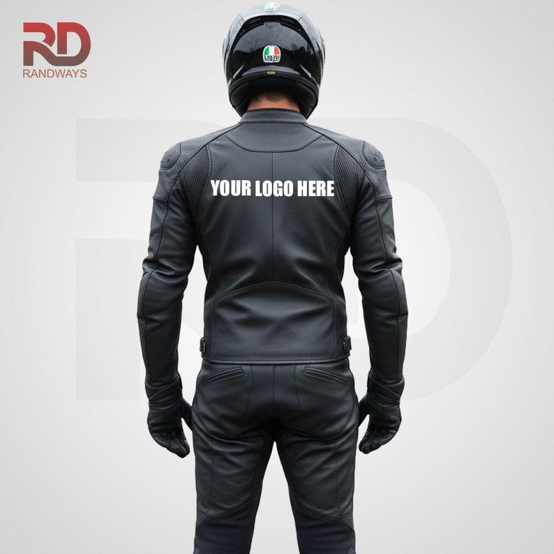 May include: Black leather motorcycle jacket and pants set. The jacket has padded shoulders and the text "YOUR LOGO HERE" on the back. The person is wearing black gloves and a black helmet.
