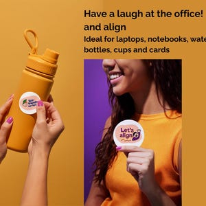 May include: Mustard-colored water bottle with a round sticker being applied. The sticker has a green and pink design with the words "Eco-friendly" and "align". The image also shows a person holding a sticker that says "Let's align".