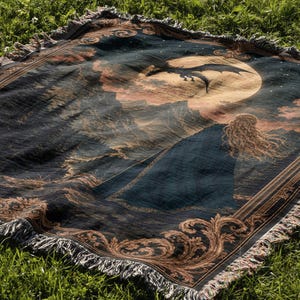 Dark teal woven textile with brown and gold swirling abstract pattern and fringed edge.