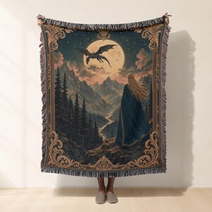Tapestry with a woman looking at a dragon flying towards a moon over mountains.