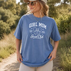 Comfort Colors t-shirt with "Girl Mom Social Club" text and bow graphic.
