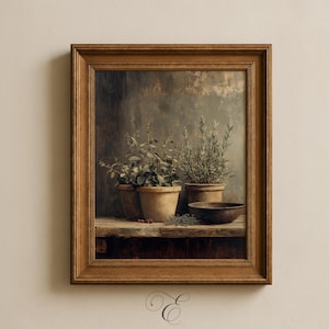 May include: A framed painting shows a still life of potted herbs and a small bowl on a wooden surface. The painting features three terracotta pots with green plants and a dark wooden bowl. The frame is a warm, medium brown.