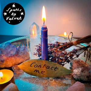 May include: A lit purple taper candle stands on a silver tray alongside a dried lavender bundle, clear quartz crystals, and a bay leaf inscribed with the text "Contact me". A circular black logo in the corner reads "Spells by Velvet".