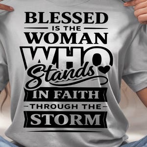 May include: A light gray t-shirt with the text "BLESSED IS THE WOMAN WHO STANDS IN FAITH THROUGH THE STORM" in black. The bottom of the image shows the text "DIGITAL DOWNLOAD FILE SVG-PNG-FILE".