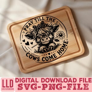 May include: A light-colored wooden cutting board with a decorative black graphic of a cow holding a flower, with the text "PRAY TILL THE COWS COME HOME." The bottom of the board has the text "DIGITAL DOWNLOAD FILE SVG-PNG-FILE."