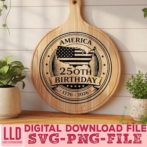 May include: A round wooden cutting board with a handle, featuring a black and white design commemorating America's 250th birthday. The design includes the American flag within a map outline, stars, and the years 1776-2026.