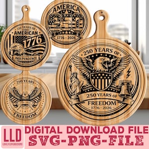 May include: Wooden cutting boards with engraved patriotic designs. The boards feature the text "250 Years of American Independence" and "250 Years of Freedom" with an eagle, the American flag, and the Statue of Liberty. The boards are round with a handle.