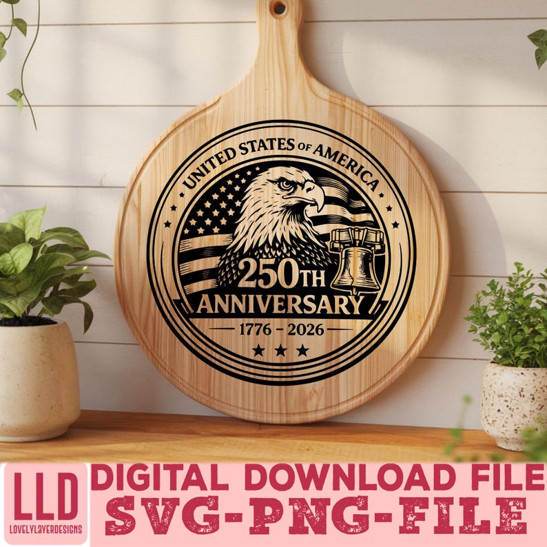 May include: A round wooden cutting board with a handle, featuring a laser-etched design commemorating the 250th anniversary of the United States. The design includes an eagle, the American flag, and the Liberty Bell. The text "UNITED STATES OF AMERICA" and "250TH ANNIVERSARY 1776-2026" are also included.
