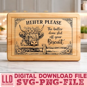 May include: A rectangular wooden cutting board with a decorative border and the text "HEIFER PLEASE". The design features a Highland cow illustration with floral accents and the phrase "The butter done slid off your Biscuit".