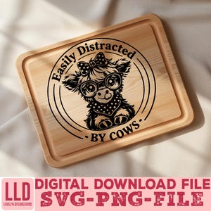 May include: A wooden cutting board with a laser-etched design of a cow wearing glasses, a bow, and a bandana. The text reads "Easily Distracted By Cows." Below the board is the text "DIGITAL DOWNLOAD FILE SVG-PNG-FILE".