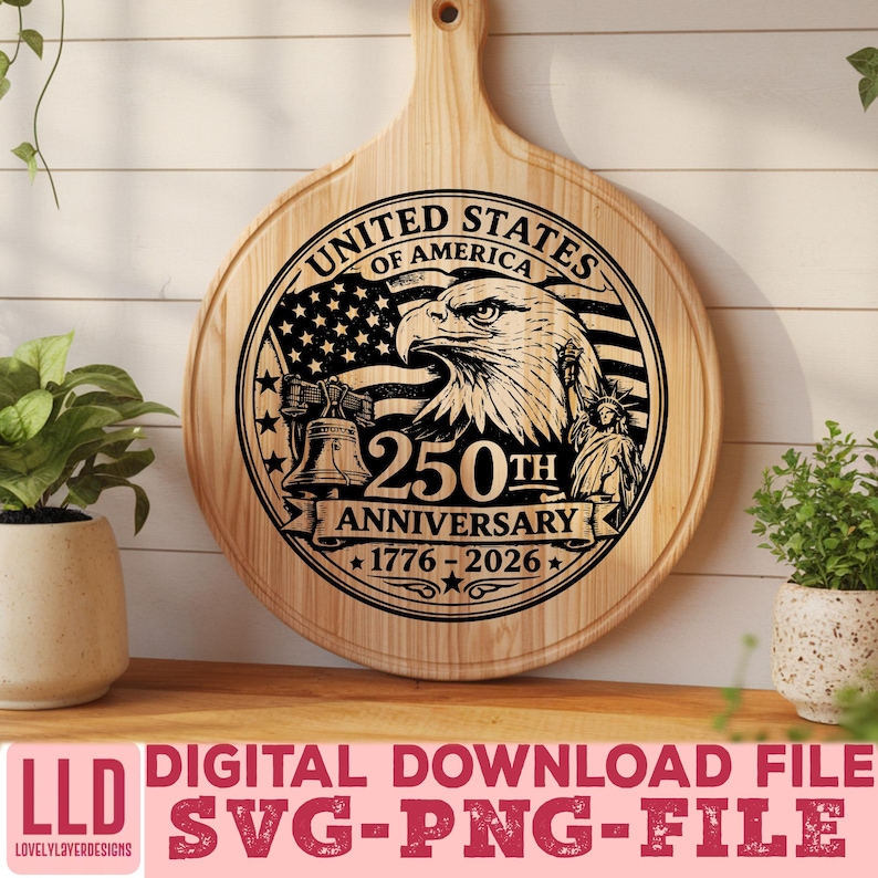 May include: A round wooden cutting board with a handle, featuring a laser-etched design commemorating the 250th anniversary of the United States. The design includes an eagle, the American flag, the Liberty Bell, and the Statue of Liberty. The text reads "United States of America" and "250th Anniversary 1776-2026".