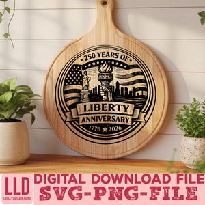 May include: A round wooden cutting board with a handle, featuring a black graphic commemorating the Liberty Anniversary. The design includes the Statue of Liberty, a waving American flag, and the text "250 Years of Liberty Anniversary 1776-2026".