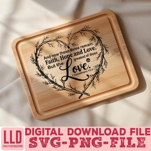 May include: A rectangular wooden chopping board featuring a heart-shaped wreath design. The wreath frames the words "Faith, Hope and Love" and "Love is" with a Bible verse reference. The board has a light wood grain.