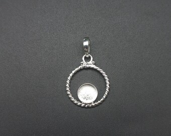 May include: A silver pendant with a circular, twisted rope design. The pendant has a small, round setting in the center and a loop at the top for a chain. The pendant is shown against a dark background.