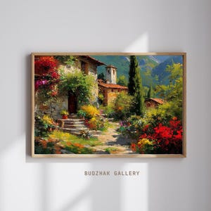 Pode incluir: Pintura emoldurada de uma cena de uma vila europeia. A obra retrata edifícios de pedra com telhados de telha vermelha, rodeados por vegetação exuberante e flores coloridas. Um caminho leva através da vila, com montanhas ao fundo. O texto "BUDZAK GALLERY" está na parte inferior.