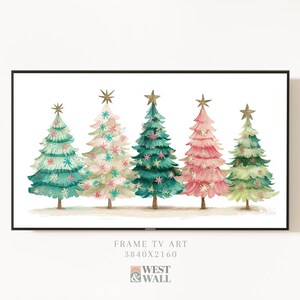 May include: Watercolor painting of five Christmas trees in a row, each a different color: teal, white, green, pink, and light green. Each tree is decorated with snowflakes and topped with a gold star. The artwork is framed in a black rectangle.