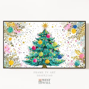 May include: Watercolor painting of a Christmas tree with colorful ornaments and a gold star on top. The tree is set against a white background with floral accents and gold speckles. The artwork is framed in black.