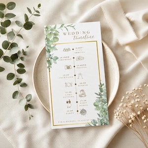 Könnte beinhalten: Eine rechteckige Hochzeits-Zeitplan-Karte mit grünen Eukalyptusblatt-Illustrationen, goldenen Randlinien und Symbolen für Veranstaltungsphasen. Der Text lautet Wedding Timeline, Guest Arrival, Ceremony, Photos, Cocktails, Dinner, Cake Cutting, First Dance, Party und Pam & Michael, 15 August 202X.
