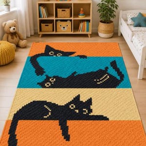 May include: A rectangular rug with a playful design featuring three black cats in a pixelated style. The rug is divided into three horizontal stripes of orange, yellow, and teal. The cats are in various relaxed poses.