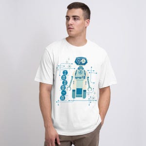 May include: White t-shirt with a retro robot design in blue and cream. The robot has a circular head, the number 4, and the word "I R B O O M" printed on the shirt. The design is surrounded by lines and starbursts, creating a vintage aesthetic.