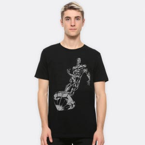 May include: A white ceramic mug with a black handle and the text "But First, Coffee" in a black, handwritten-style font. The mug is on a white surface.