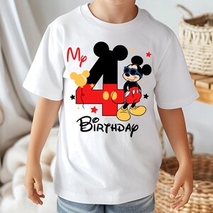 May include: White t-shirt featuring a colorful Mickey Mouse design for a fourth birthday. The design includes a large number 4, Mickey Mouse in sunglasses, the words "My Birthday", and star accents. The shirt is short-sleeved.