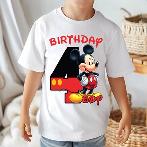 May include: White t-shirt with a Mickey Mouse graphic and the text "BIRTHDAY 4 BOY" in red. Mickey Mouse is in red shorts, yellow shoes, and white gloves. The number 4 is black with red and yellow accents.