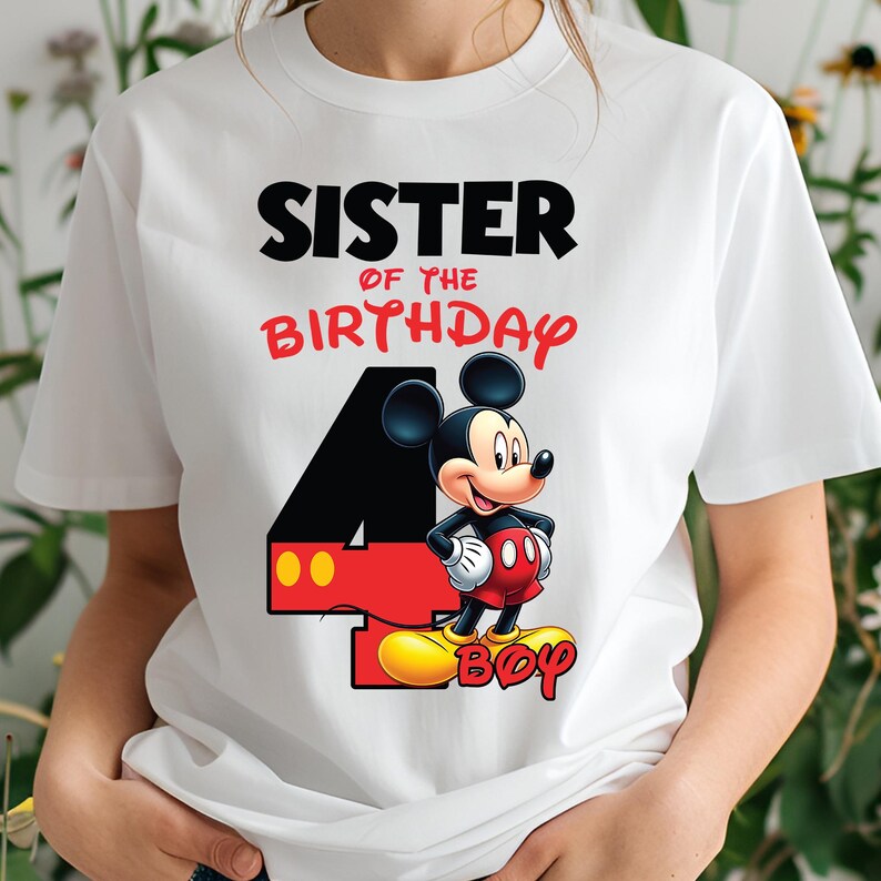 May include: White t-shirt with a Mickey Mouse graphic and the text "SISTER OF THE BIRTHDAY 4 BOY." The design includes a large black number 4 with red and yellow accents, and Mickey Mouse is wearing red shorts and yellow shoes.