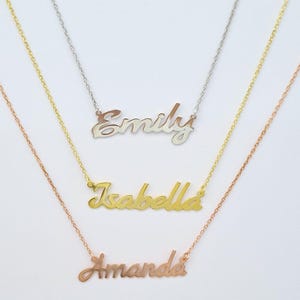May include: Three necklaces with name pendants: "Emily" in silver, "Isabella" in gold, and "Amanda" in rose gold. Each necklace features a delicate chain and a cursive name design, perfect for personalized jewelry.