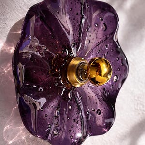 May include: A set of three ceramic mugs with a speckled, matte finish. The mugs are in shades of cream, light gray, and dark gray. Each mug has a simple, minimalist design and a rounded handle.