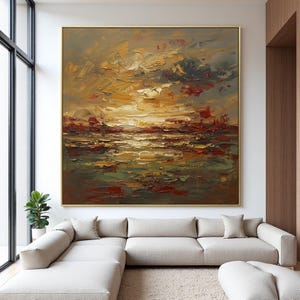 May include: Large abstract oil painting with a gold frame. The artwork features a textured landscape with a sunset over water. Colors include shades of yellow, orange, red, green, and gray. The painting is displayed above a beige sectional sofa.