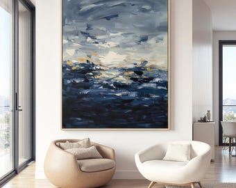 May include: Large abstract painting with a gold frame. The artwork features a dark blue and white color palette, with brushstrokes creating a textured effect. The painting depicts a seascape or landscape.