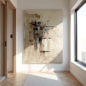 May include: Large abstract painting with a neutral color palette of beige, brown, and black. The artwork features a textured surface with layered brushstrokes and geometric shapes, creating a modern and artistic aesthetic. The painting is displayed in a well-lit room.