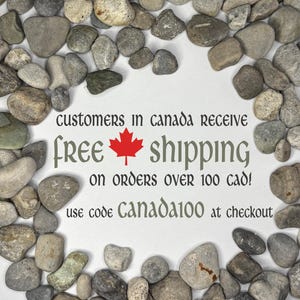 May include: A collection of smooth, multi-colored river stones arranged in a circular border around white space containing the text: CUSTOMERS IN CANADA RECEIVE free shipping ON ORDERS OVER 100 CAD! use code CANADA100 at checkout.