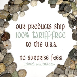 May include: A circular arrangement of smooth, multi-colored river stones surrounding text that reads: Our products ship 100% tariff-free to the U.S.A. No surprise fees! Updated 24-August-2026. The stones are various shades of gray, brown, and tan.