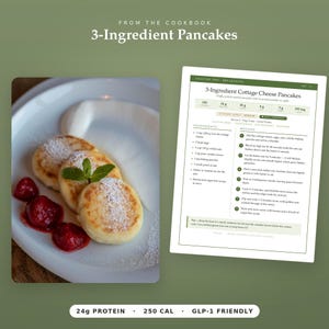 May include: A recipe card titled 3-Ingredient Cottage Cheese Pancakes with a list of ingredients and instructions, alongside a white plate holding three golden-brown pancakes topped with powdered sugar, fresh strawberries, and a mint sprig.