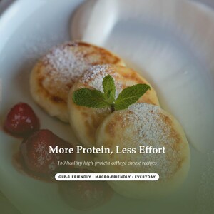 May include: Three golden-brown cottage cheese pancakes topped with powdered sugar and a fresh mint sprig, served with red strawberries. Text reads: More Protein, Less Effort, 150 healthy high-protein cottage cheese recipes, GLP-1 FRIENDLY - MACRO-FRIENDLY - EVERYDAY.
