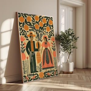 May include: A framed art print depicting a couple beneath an orange tree, rendered in a stylized illustration. The artwork uses orange, green, and cream tones, with floral and botanical motifs. The couple is dressed in traditional clothing.