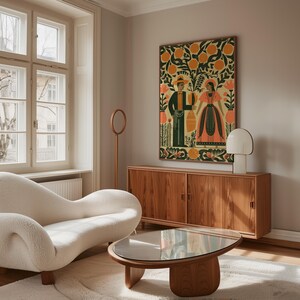 May include: A living room interior with a cream sofa, wooden coffee table, and a wooden cabinet. A large framed artwork in a folk art style, showing two figures and orange trees, hangs above the cabinet. A modern lamp and a circular floor lamp are also visible.