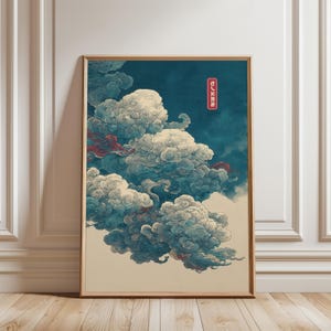 May include: A framed print featuring a stylized depiction of clouds in shades of white, blue, and red against a dark blue background. The artwork has a vintage aesthetic, with a Japanese text in a red box in the upper right corner.
